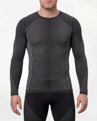 A model wears the STRAUSS e.s.trail pure Warm Seamless Thermal Long Sleeve Shirt in black and basalt gray as a cold-weather base layer in a studio product scene