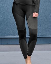 Women's Warm Seamless Thermal Pants e.s.trail pure in black/basalt gray worn in a work setting