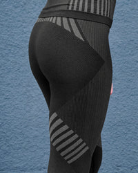 Lifestyle view of Women's Warm Seamless Thermal Pants e.s.trail pure in black/basalt gray during work