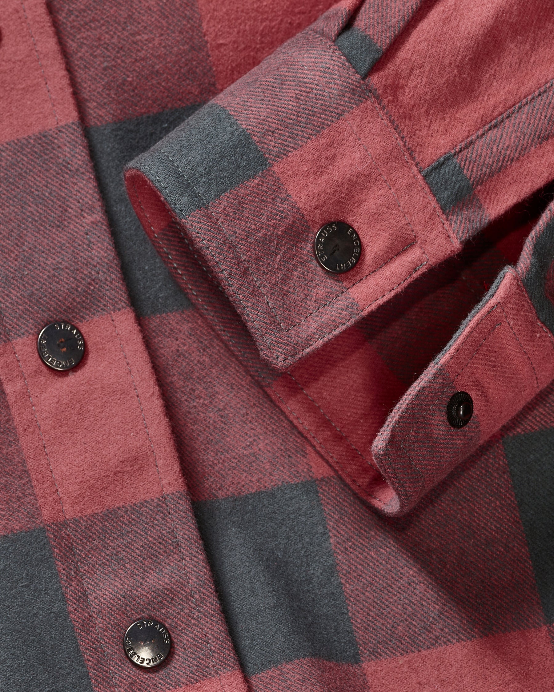 Plaid flannel fabric, button placket, and chest pocket on the STRAUSS e.s.iconic Flannel Work Shirt in oxid red and carbon gray