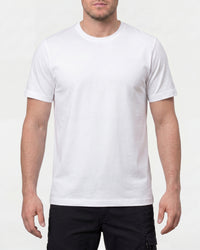 A model wears the STRAUSS Cotton T-Shirt in white with tan work pants and work boots in a studio product scene