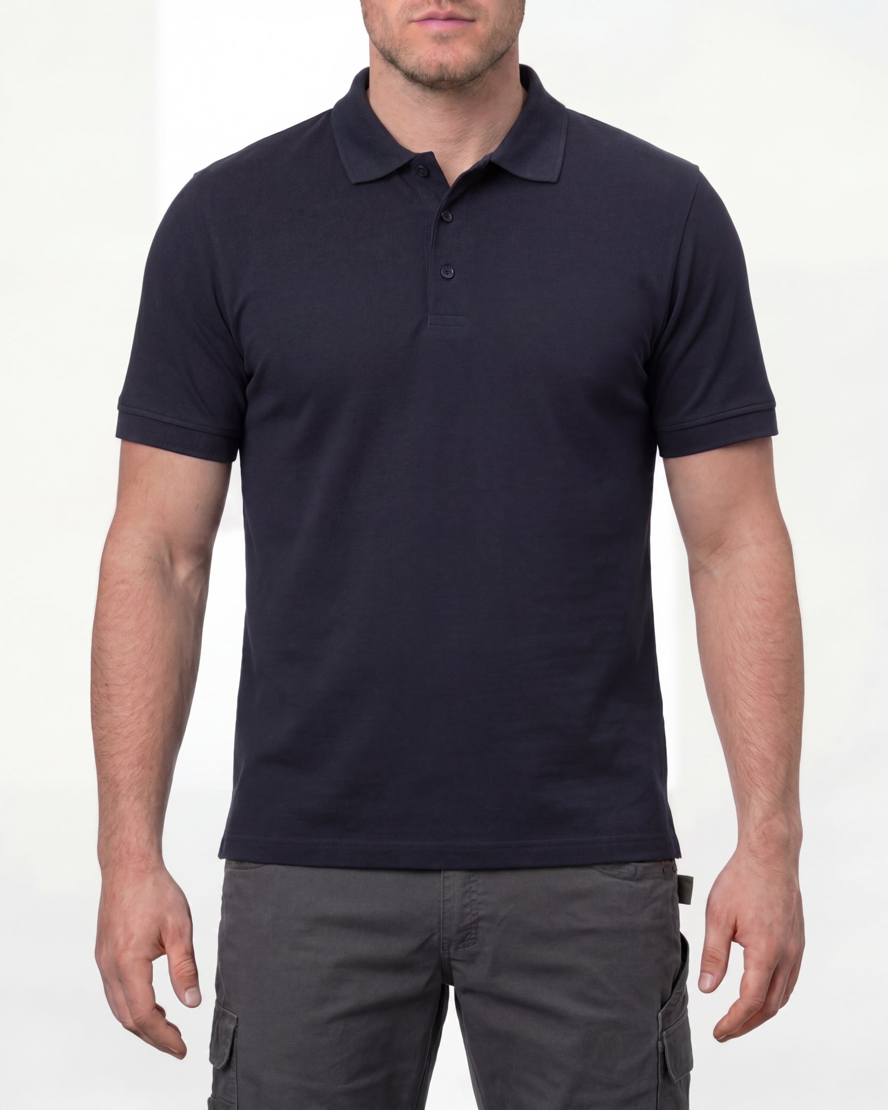 A model wears the STRAUSS Cotton Polo Shirt in nero blue with tan work pants and work boots in a studio product scene
