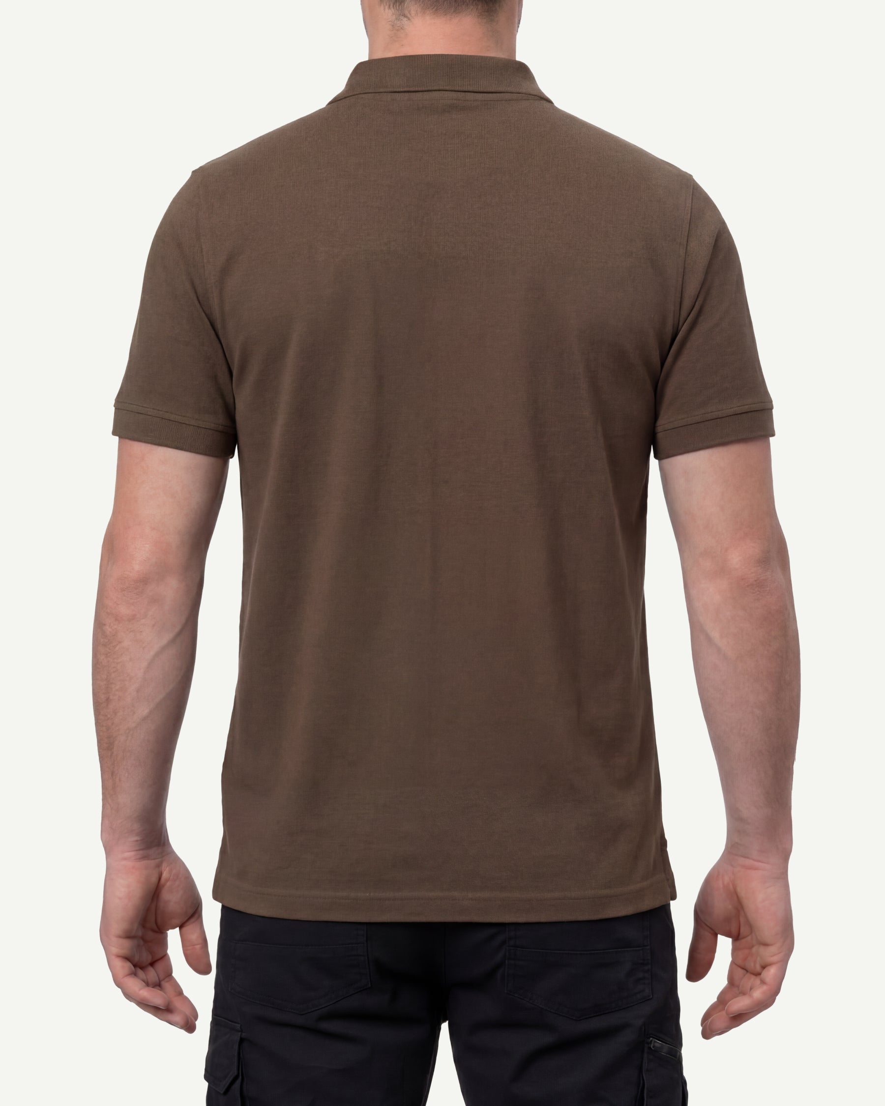 A model wears the STRAUSS Cotton Polo Shirt in hazelnut with tan work pants and work boots, showing the shirt fit