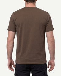 A model wears the STRAUSS Cotton T-Shirt in hazelnut with tan work pants and work boots, showing the shirt fit