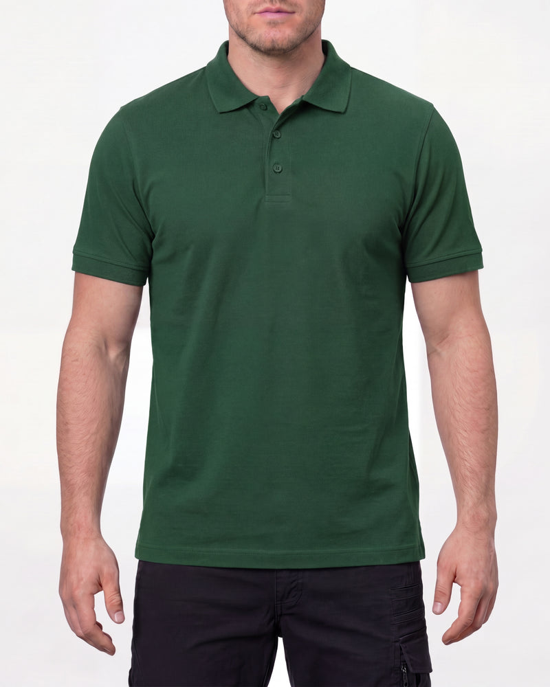 A model wears the STRAUSS Cotton Polo Shirt in green with tan work pants and work boots in a studio product scene