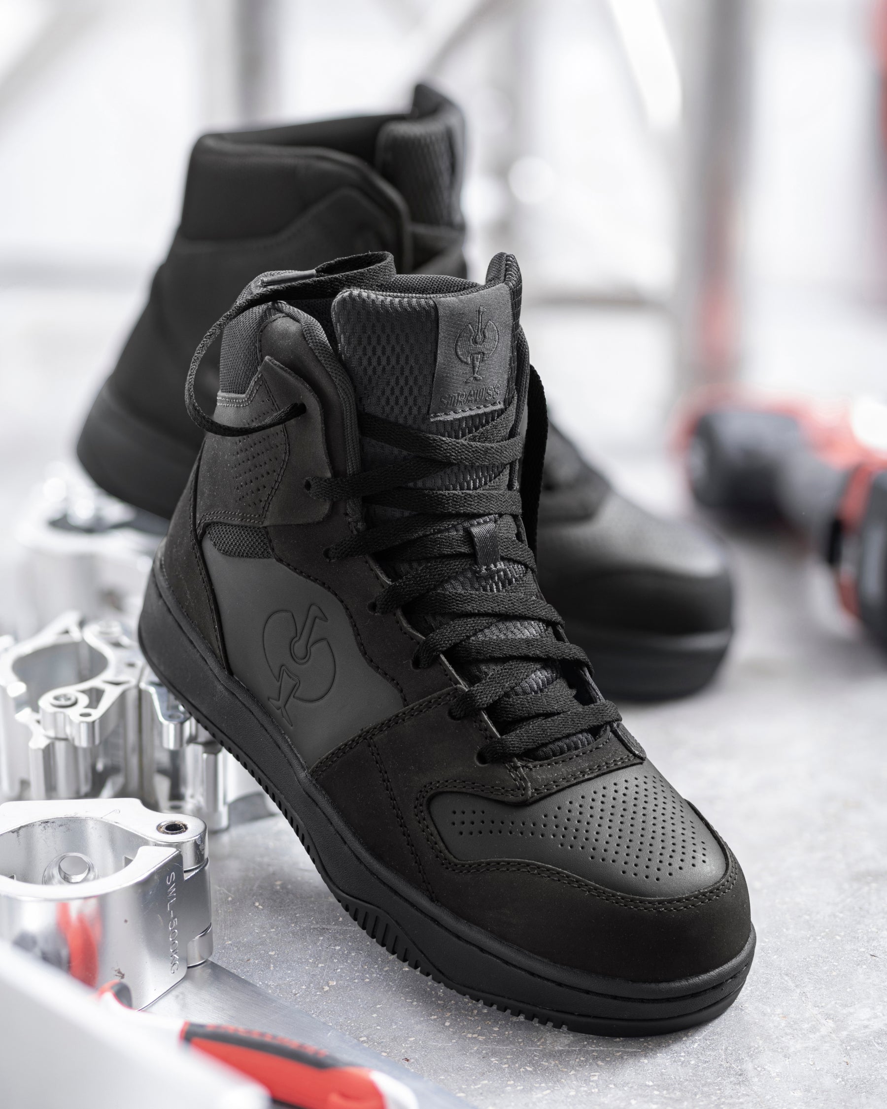 STRAUSS Eindhoven 6-inch Steel Toe Work Boot in Black worn in an outdoor work setting