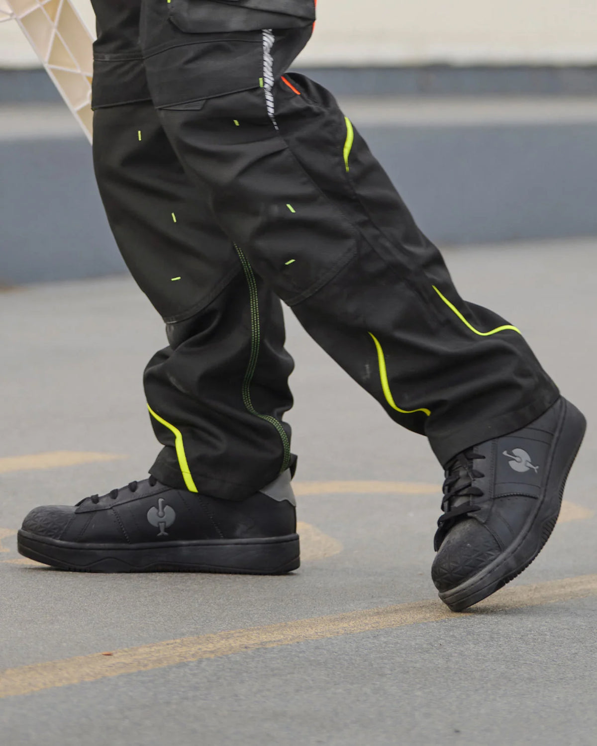STRAUSS Philly Steel Toe Work Shoe in Black shown on rough jobsite ground