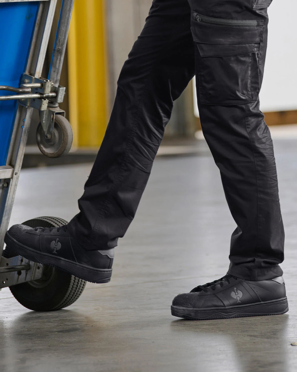 STRAUSS Philly Steel Toe Work Shoe in Black worn in an outdoor work setting