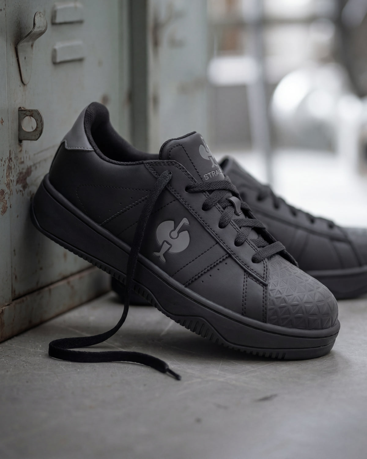 STRAUSS Philly Steel Toe Work Shoe in Black with workwear in a jobsite scene