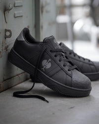 STRAUSS Philly Steel Toe Work Shoe in Black with workwear in a jobsite scene
