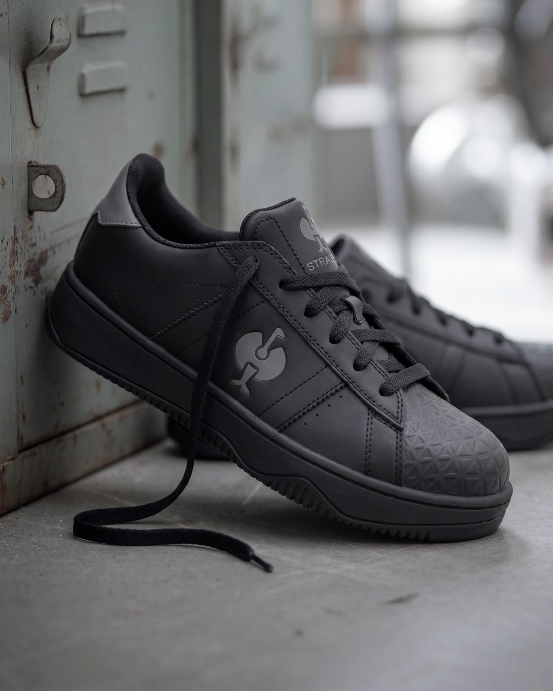 STRAUSS Philly Steel Toe Work Shoe in Black with workwear in a jobsite scene