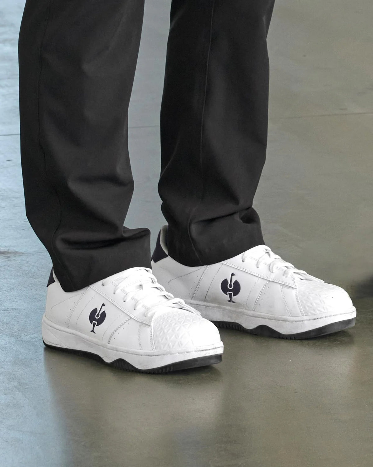 STRAUSS Philly Steel Toe Work Shoe in White and Black shown on rough jobsite ground