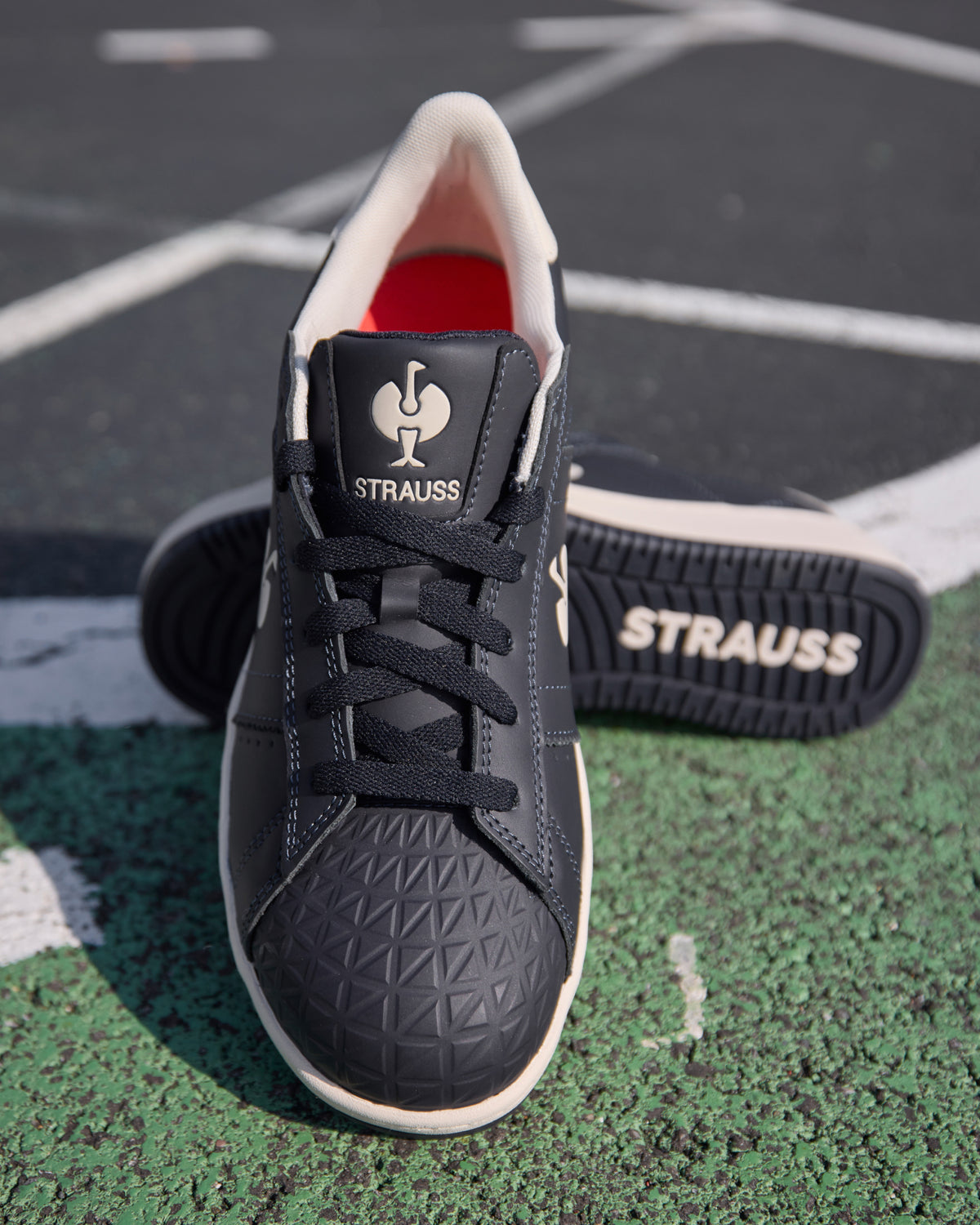 STRAUSS Philly Steel Toe Work Shoe in Nero blue shown on rough jobsite ground