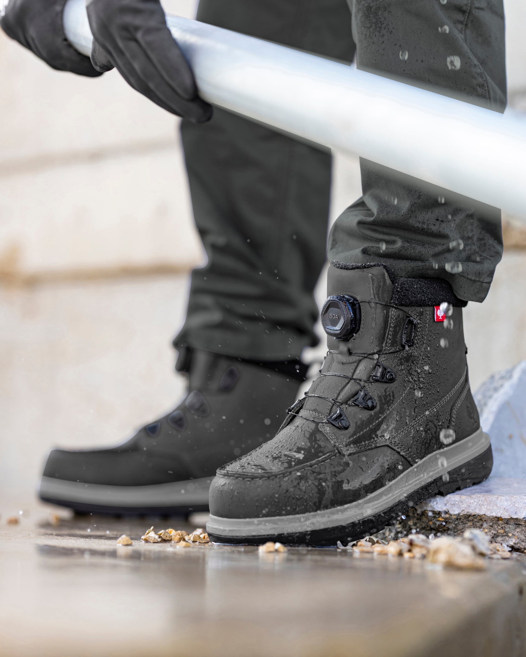 STRAUSS Woodside 6-inch Steel Toe Work Boot in Carbon gray shown on rough jobsite ground