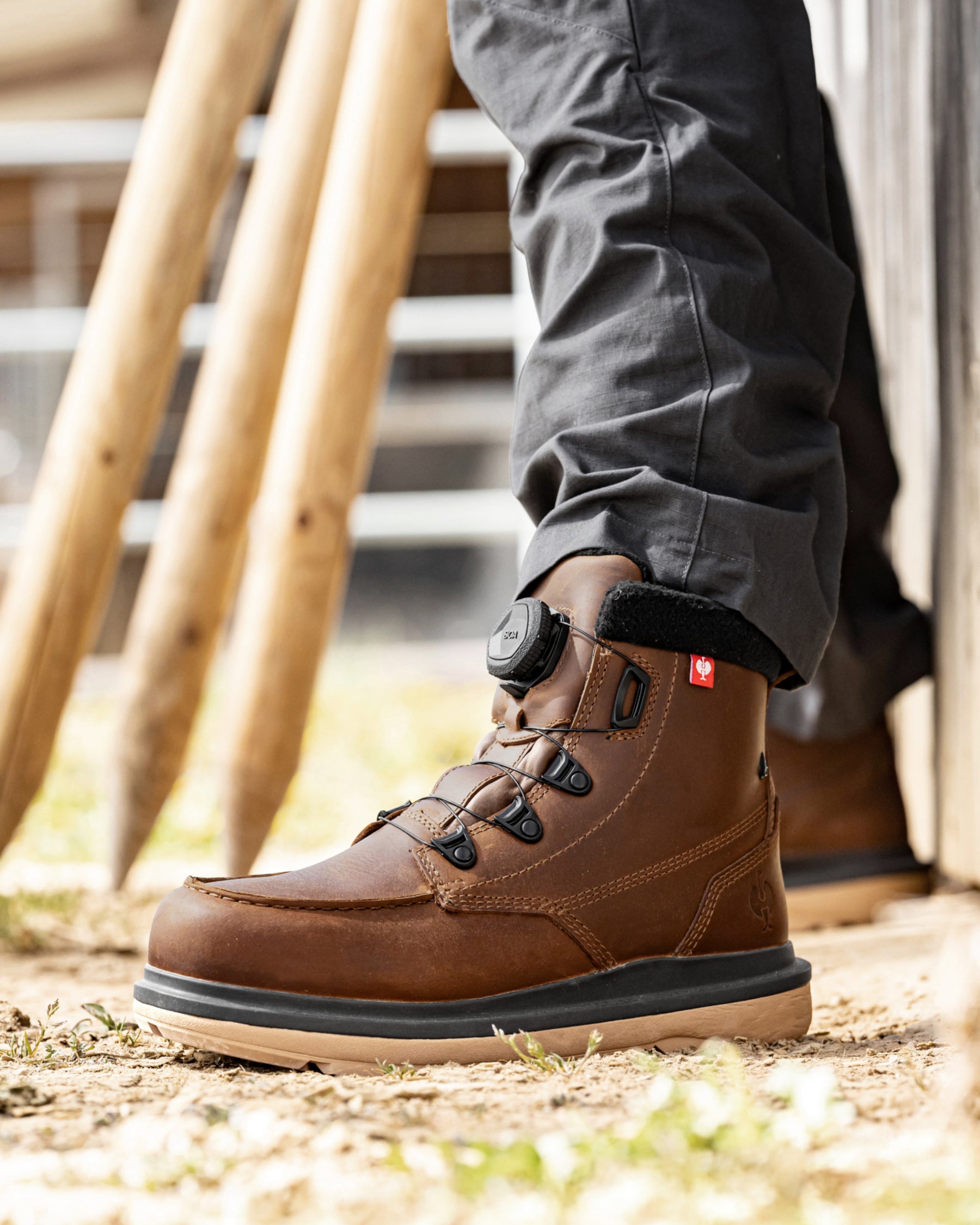 STRAUSS Woodside 6-inch Steel Toe Work Boot in Desert brown shown on rough jobsite ground