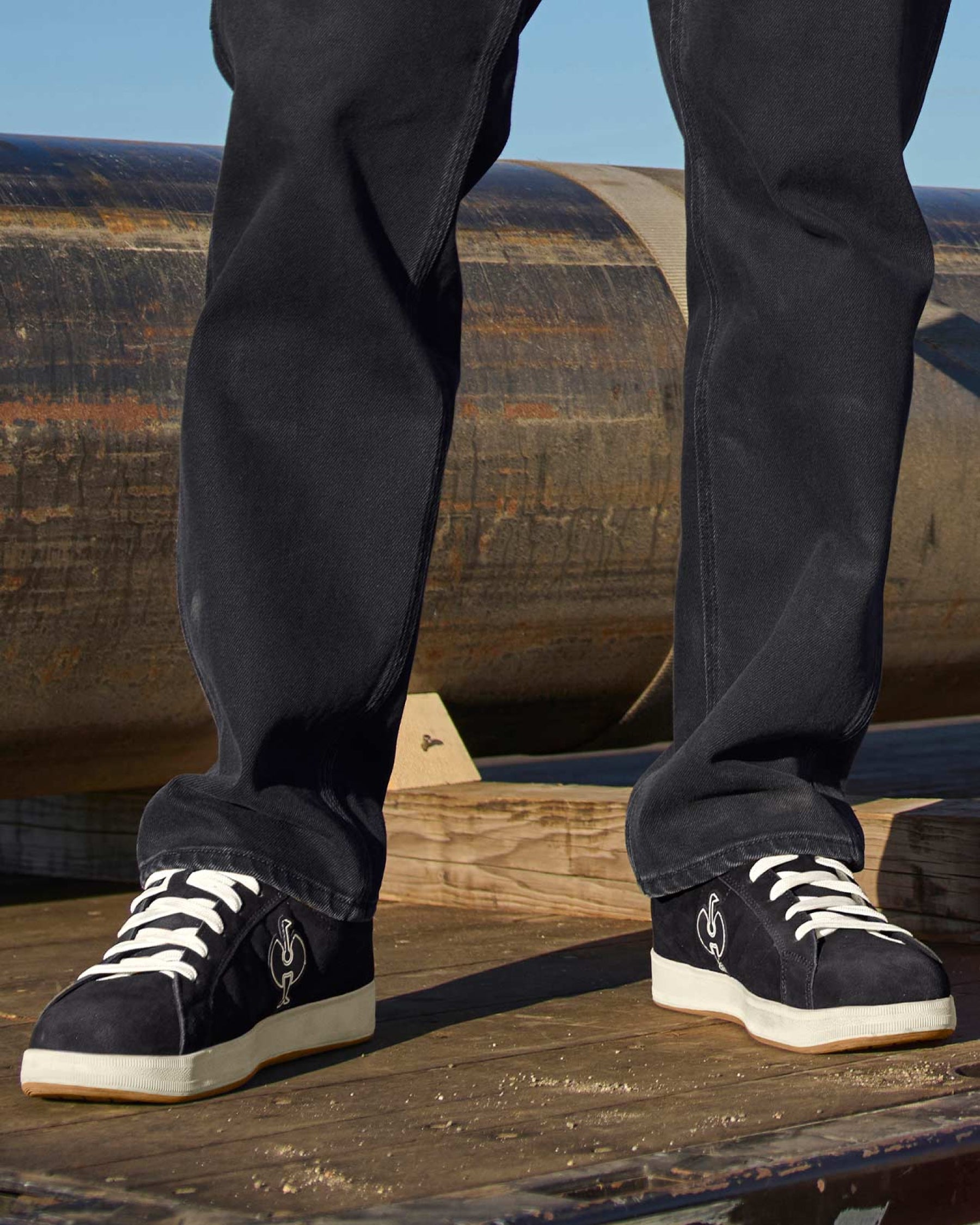 STRAUSS Tampa Steel Toe Work Shoe in Black and Light beige shown on rough jobsite ground