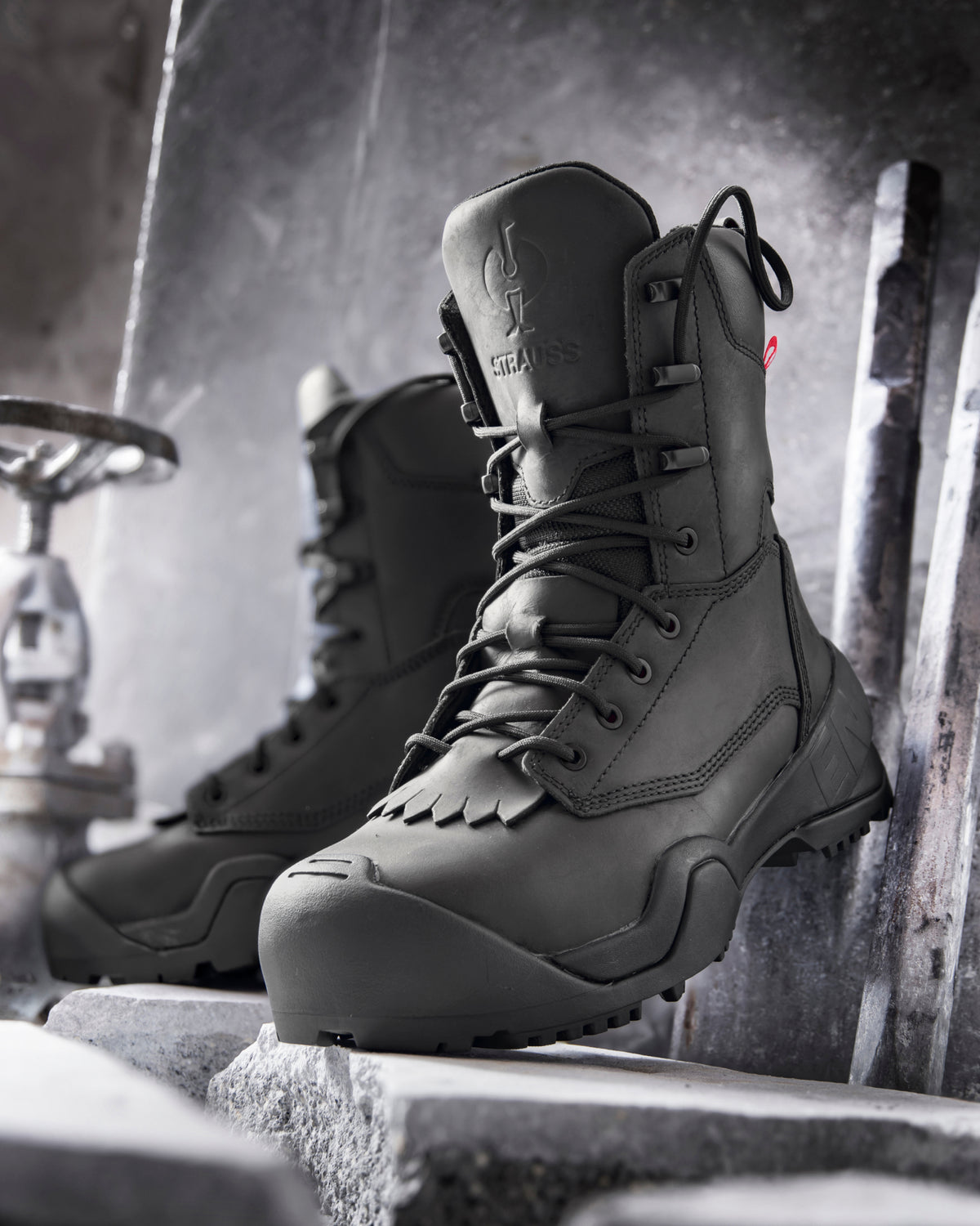 STRAUSS Edmonton 8-inch Steel Toe Work Boot in Black shown on rough jobsite ground