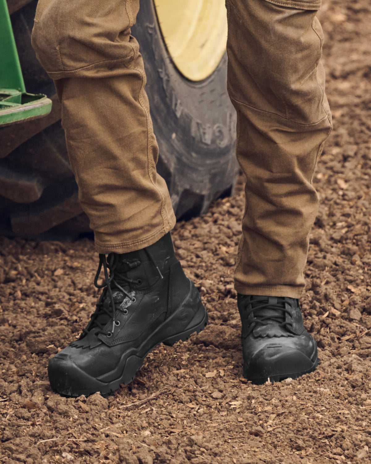 STRAUSS Edmonton 8-inch Steel Toe Work Boot in Black worn in an outdoor work setting