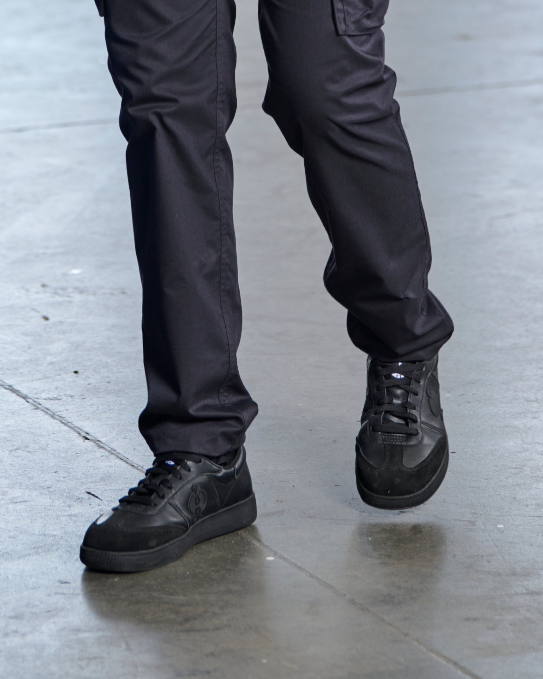 STRAUSS Brooklyn Steel Toe Work Shoe in Black shown on rough jobsite ground