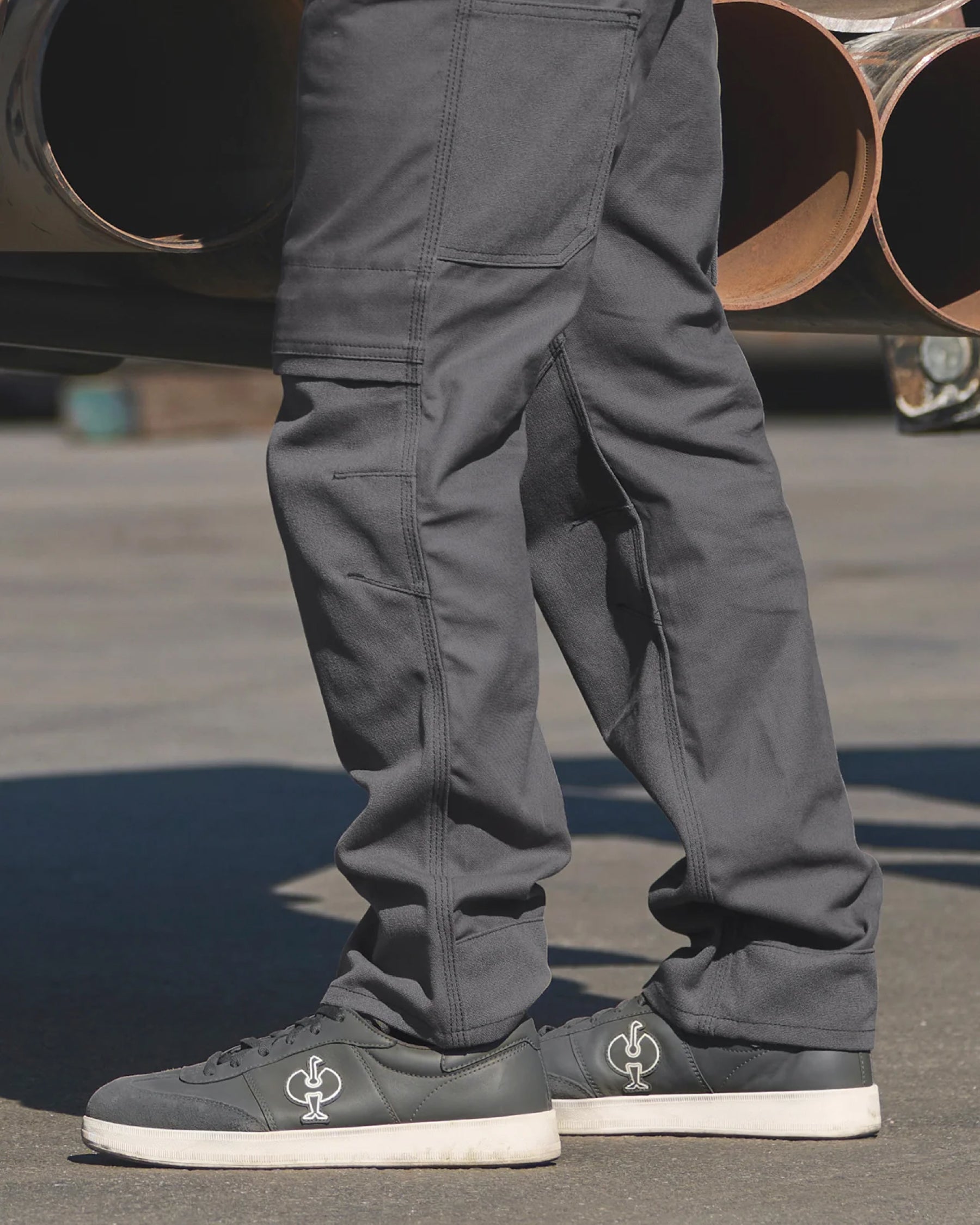 STRAUSS Brooklyn Steel Toe Work Shoe in Carbon gray shown on rough jobsite ground