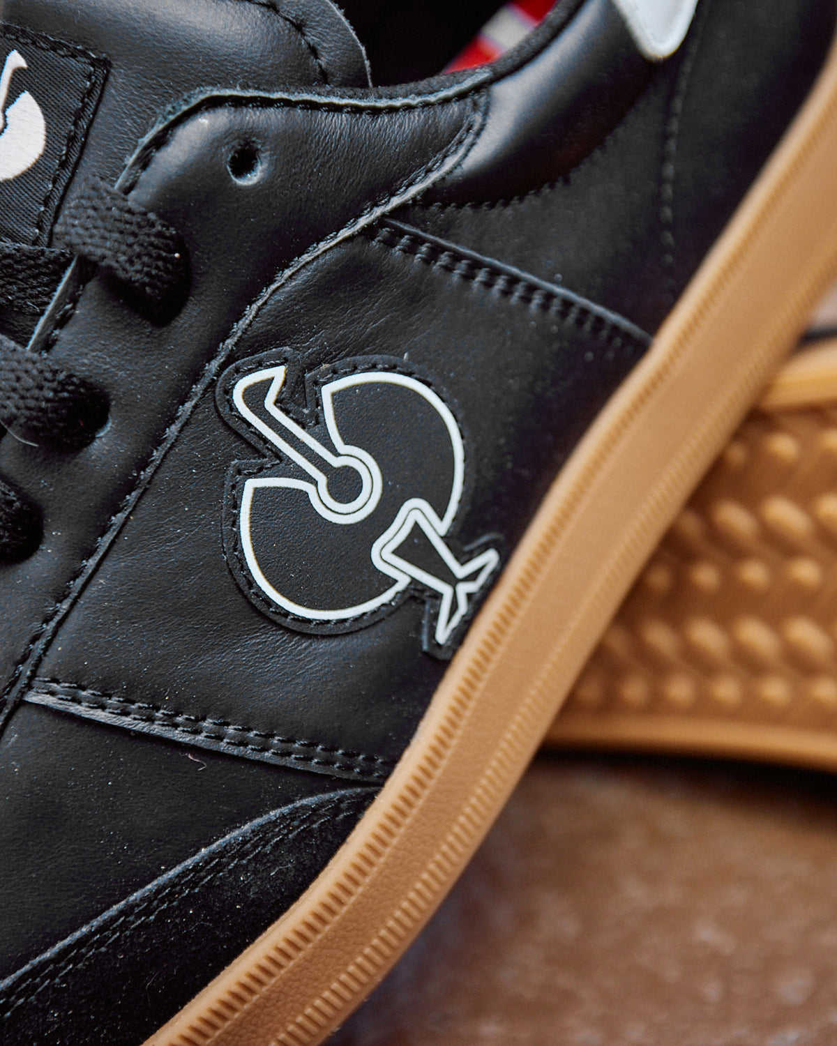 Close-up of the Black and White Brooklyn Steel Toe Work Shoe STRAUSS logo