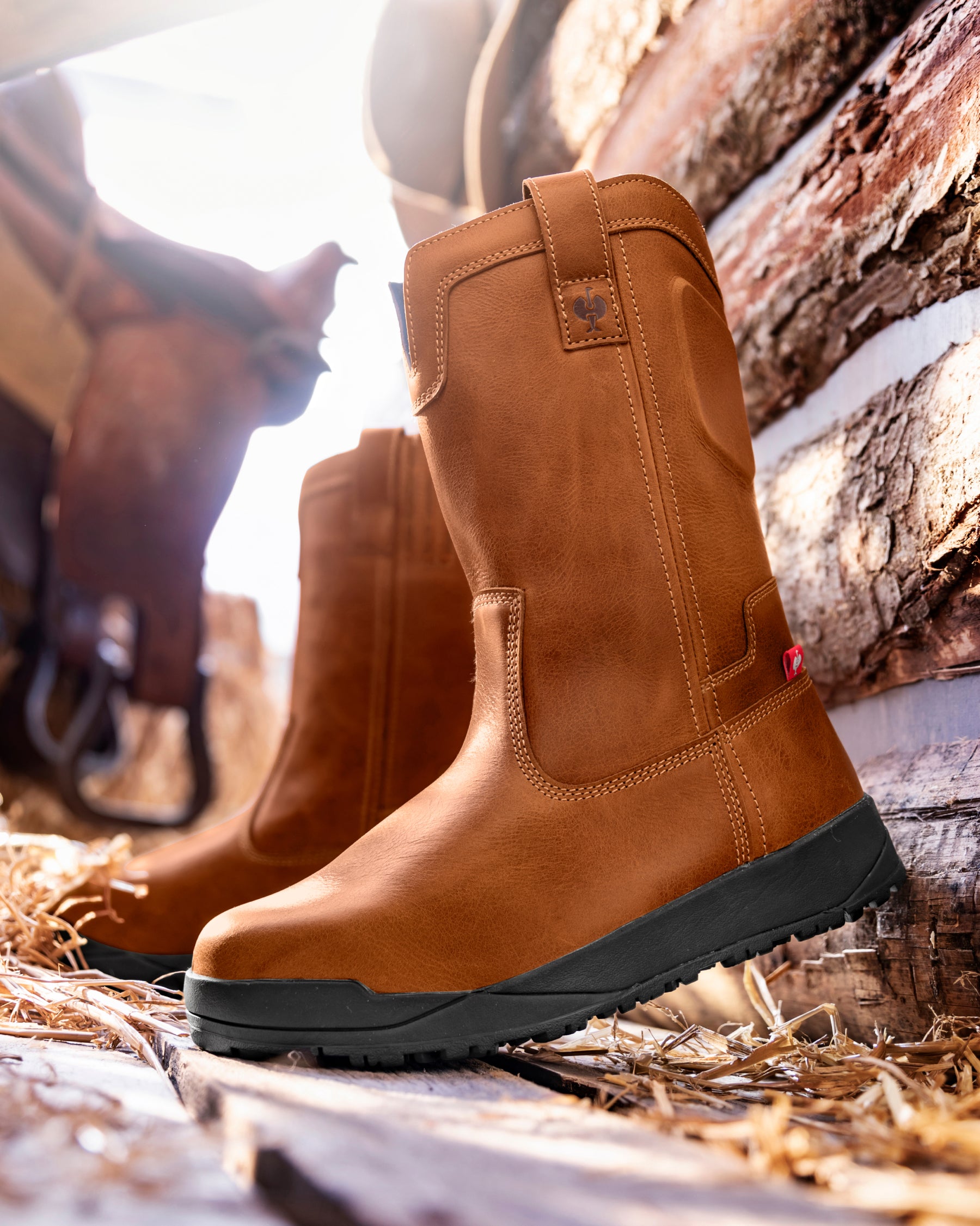 STRAUSS Kingston 11-inch Steel Toe Work Boot in Light brown shown on rough jobsite ground