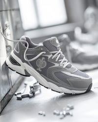 STRAUSS St. Louis Composite Toe Work Shoe in Pearl gray shown on rough jobsite ground