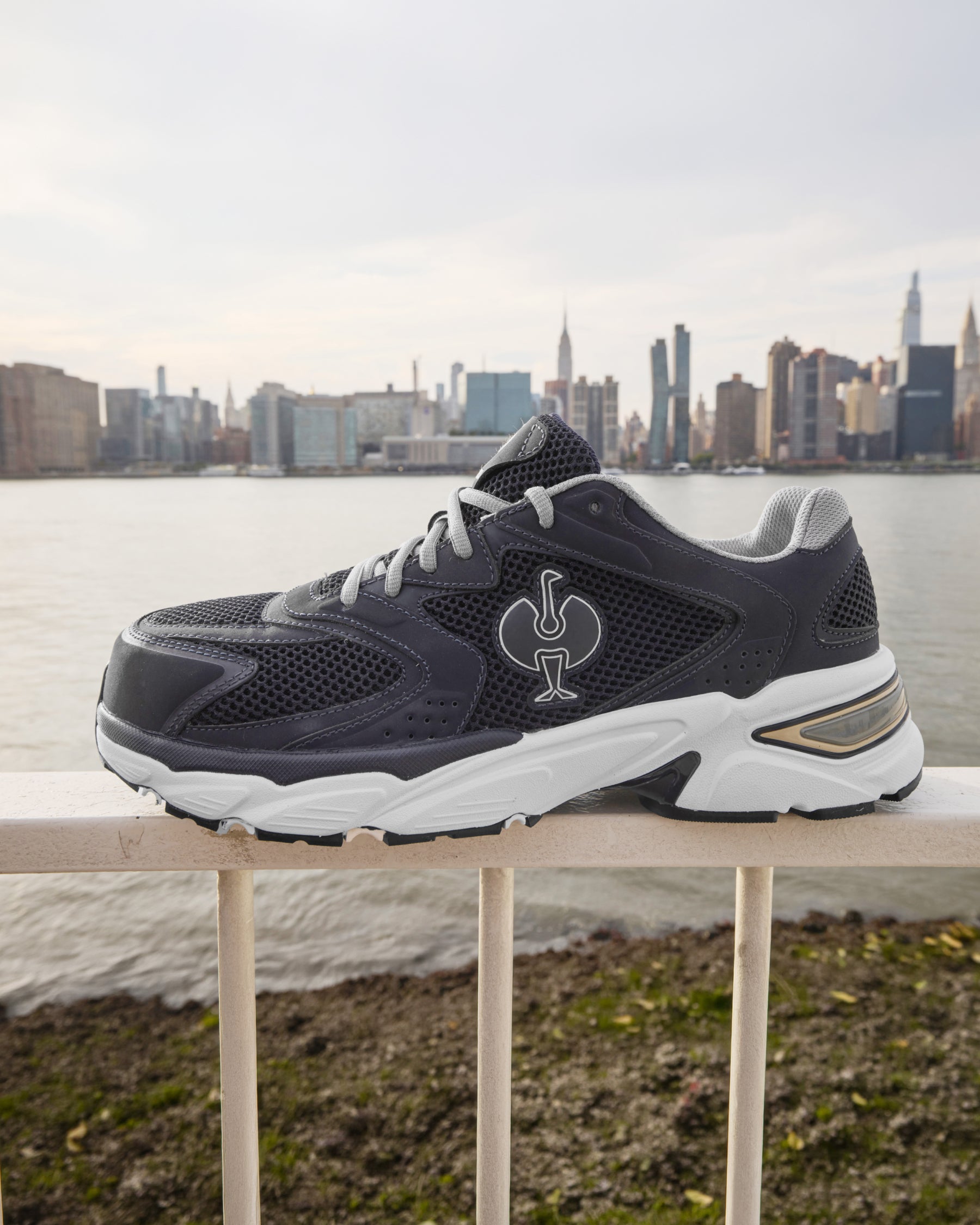 STRAUSS St. Louis Composite Toe Work Shoe in Nero blue shown on rough jobsite ground