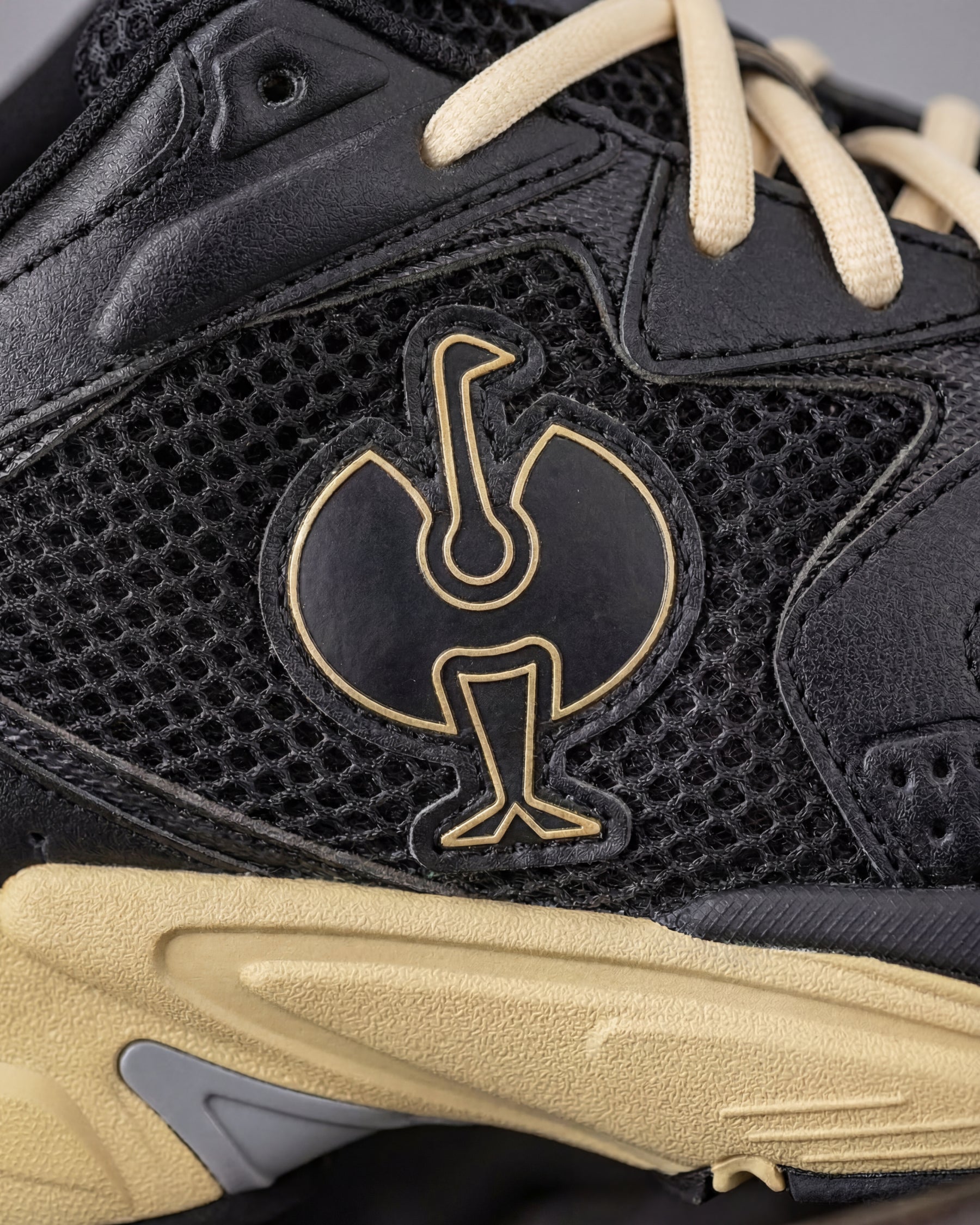 Close-up of the Black and Sand St. Louis Composite Toe Work Shoe STRAUSS logo