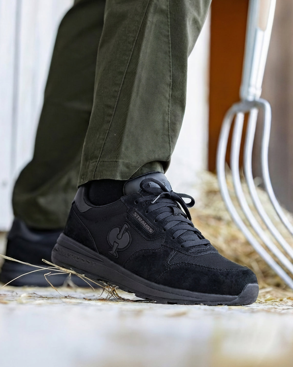 STRAUSS Canberra Steel Toe Work Shoe in Black shown on rough jobsite ground