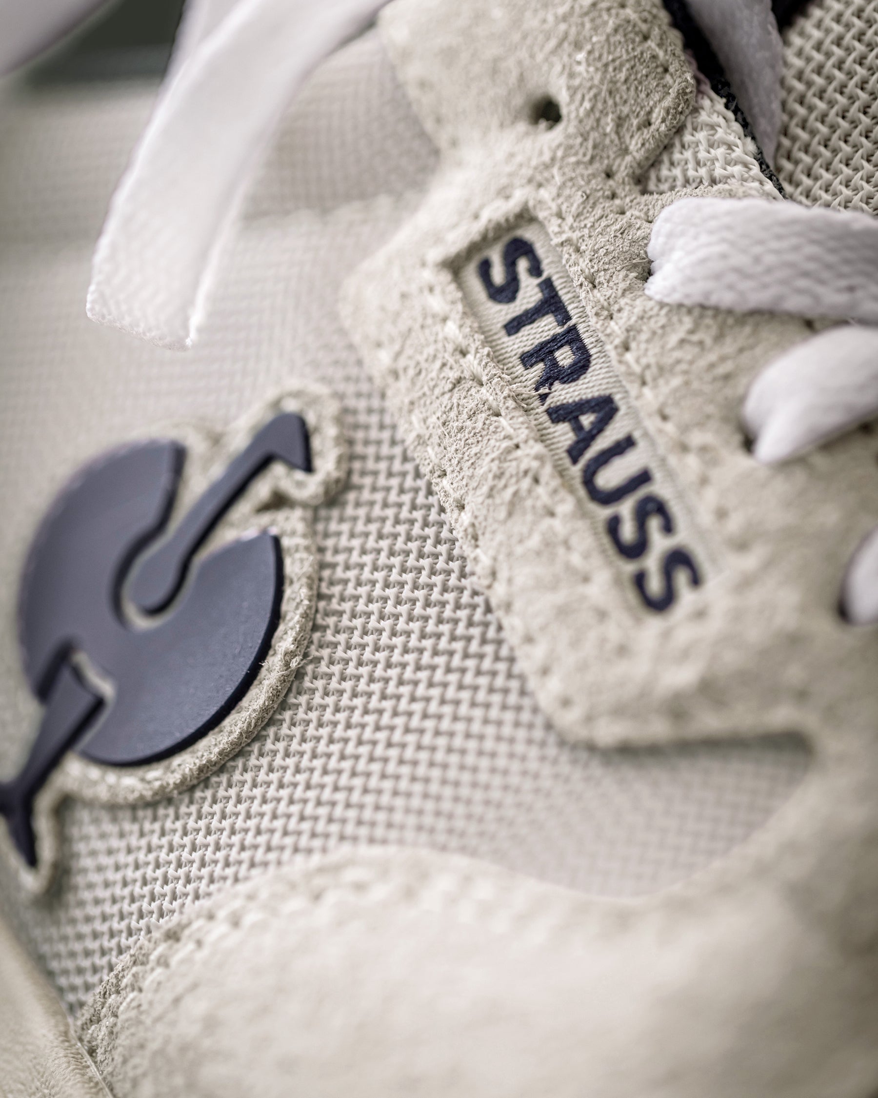 Close-up of the Canberra Steel Toe Work Shoe STRAUSS logo