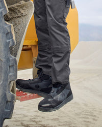 STRAUSS Murcia 6-inch Steel Toe Work Boot in Carbon gray and Black worn in an outdoor work setting