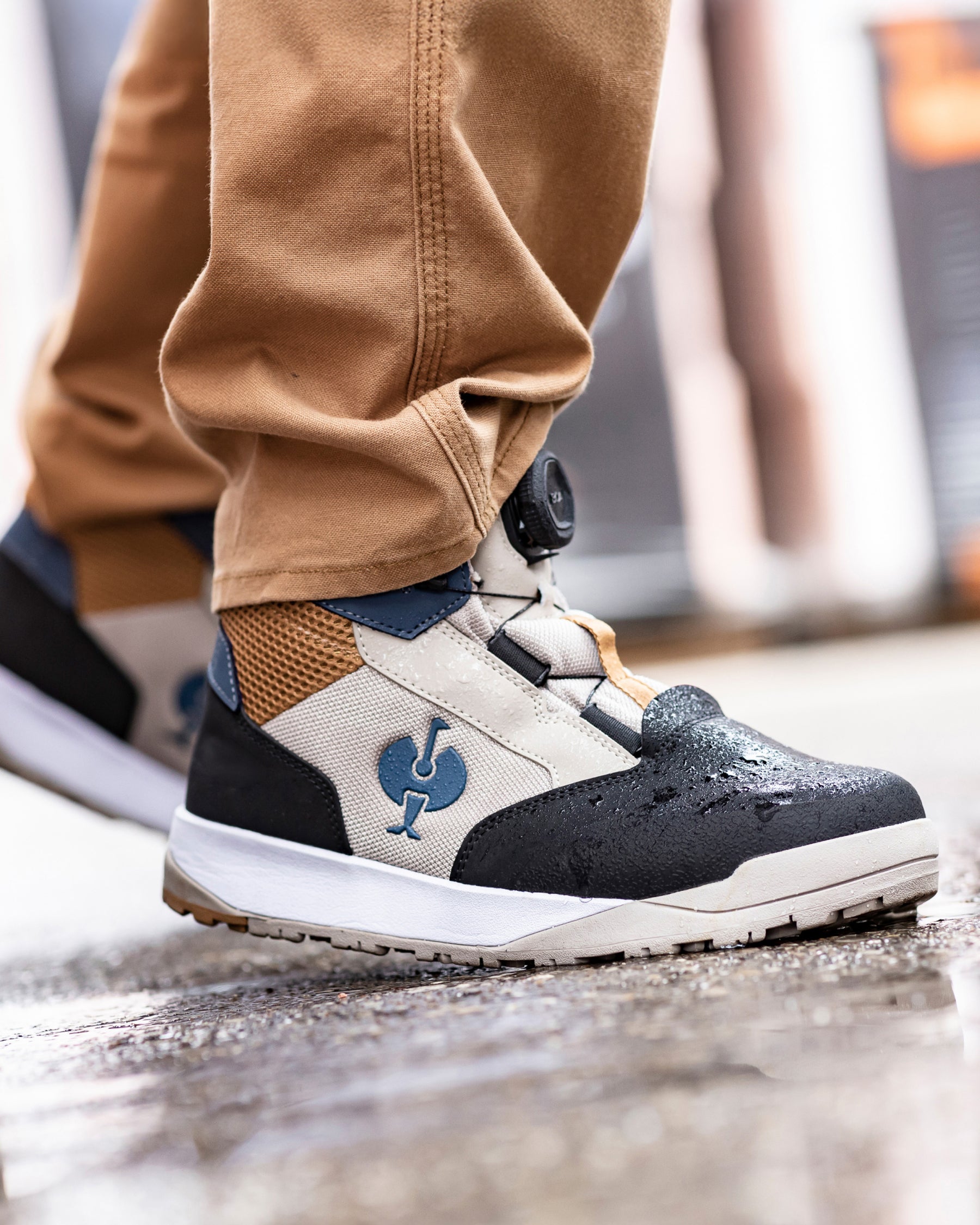 STRAUSS Murcia 6-inch Steel Toe Work Boot in Black, Dolphin gray, and Almond brown shown on rough jobsite ground