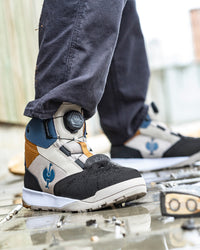 STRAUSS Murcia 6-inch Steel Toe Work Boot in Black, Dolphin gray, and Almond brown worn in an outdoor work setting