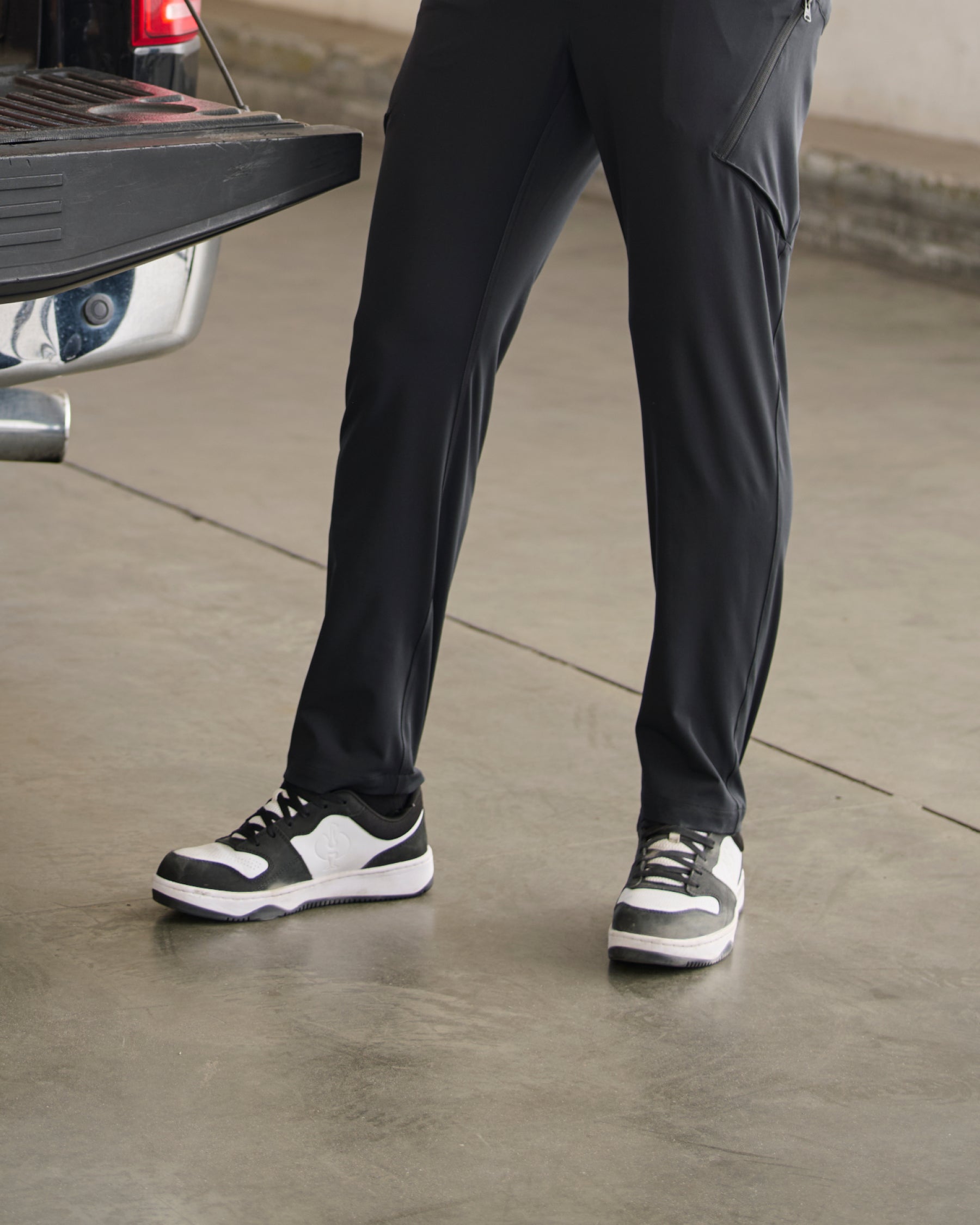 STRAUSS Eindhoven Steel Toe Work Shoe in Black and White shown on rough jobsite ground