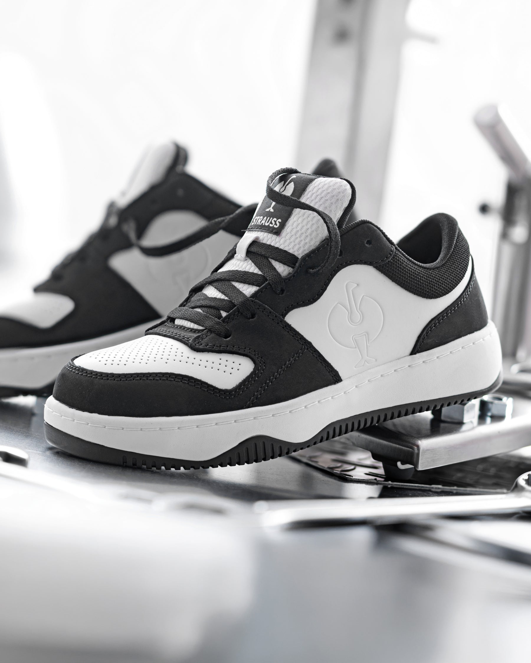 STRAUSS Eindhoven Steel Toe Work Shoe in Black and White worn in an outdoor work setting