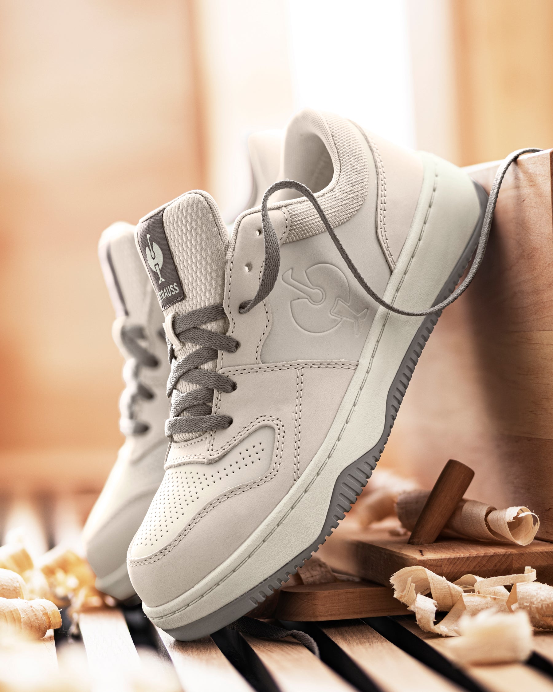 STRAUSS Eindhoven Steel Toe Work Shoe in Cream stone and Gray shown on rough jobsite ground