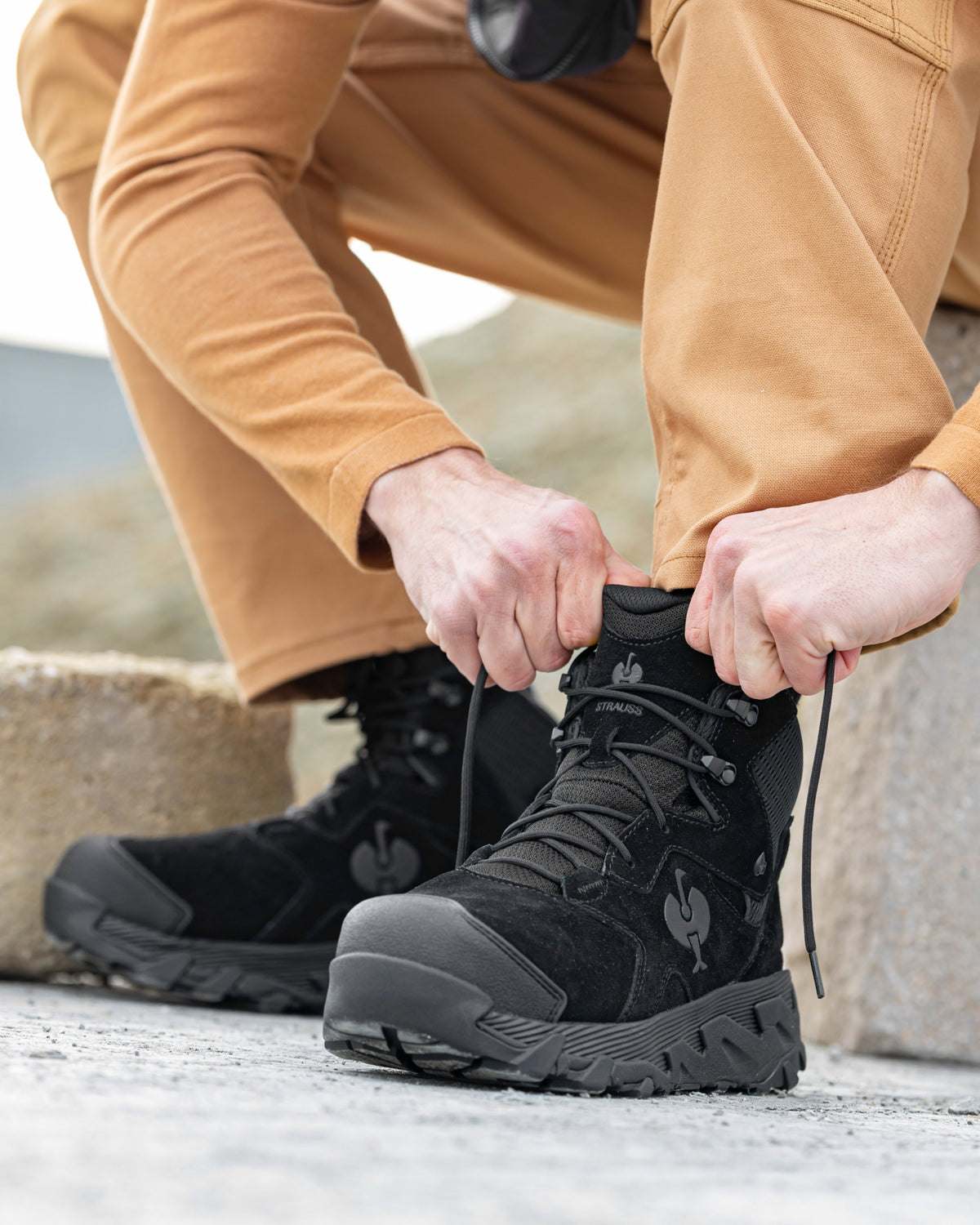 STRAUSS Turin 6-inch Aluminum Toe Work Boot in Black shown on rough jobsite ground
