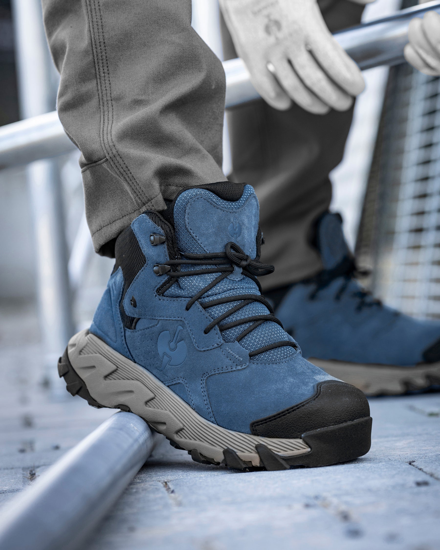 STRAUSS Turin 6-inch Aluminum Toe Work Boot in Oxid blue shown on rough jobsite ground