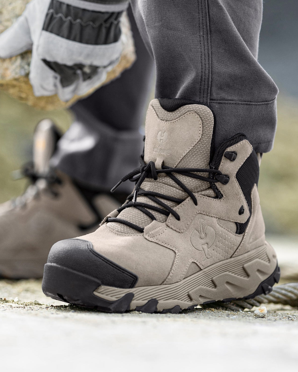 STRAUSS Turin 6-inch Aluminum Toe Work Boot in Dolphin gray shown on rough jobsite ground