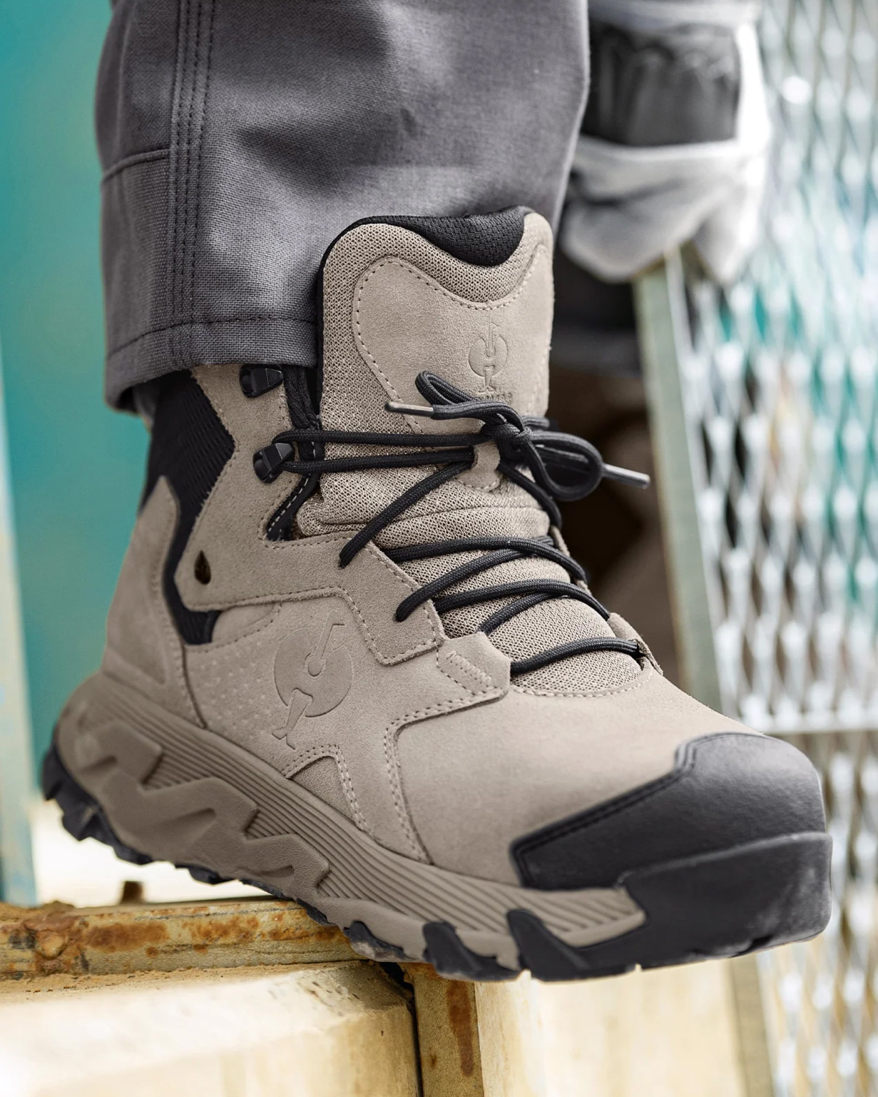 STRAUSS Turin 6-inch Aluminum Toe Work Boot in Dolphin gray worn in an outdoor work setting