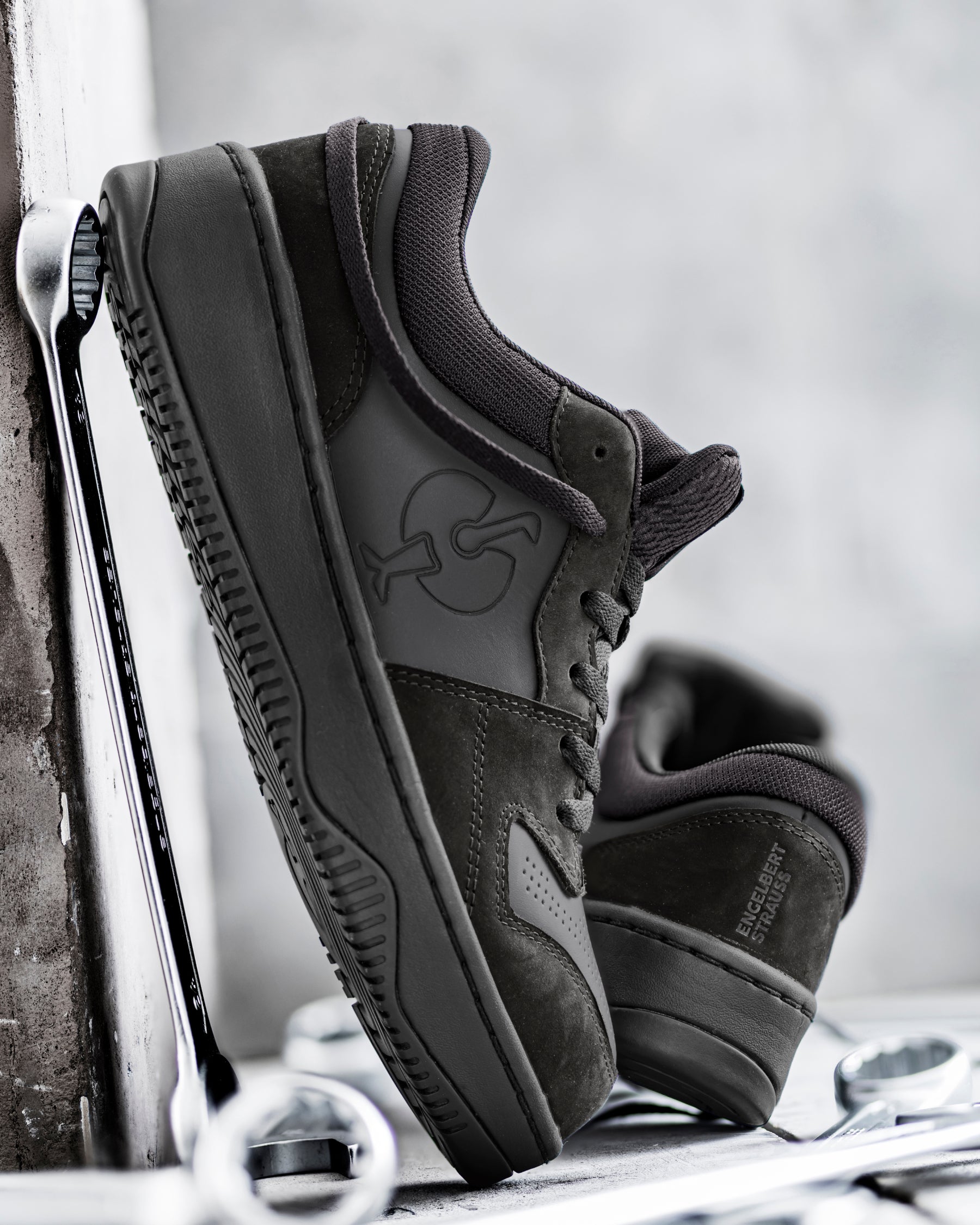 STRAUSS Eindhoven Steel Toe Work Shoe in Black shown on rough jobsite ground