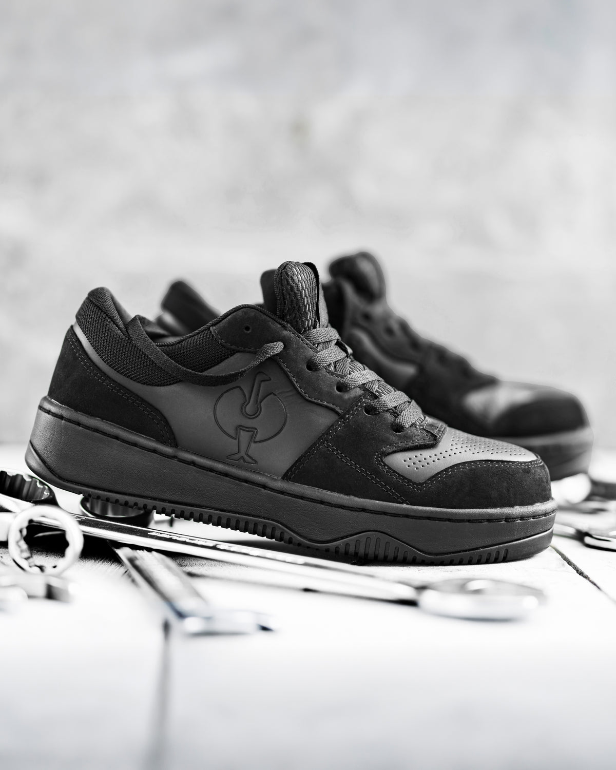 STRAUSS Eindhoven Steel Toe Work Shoe in Black worn in an outdoor work setting