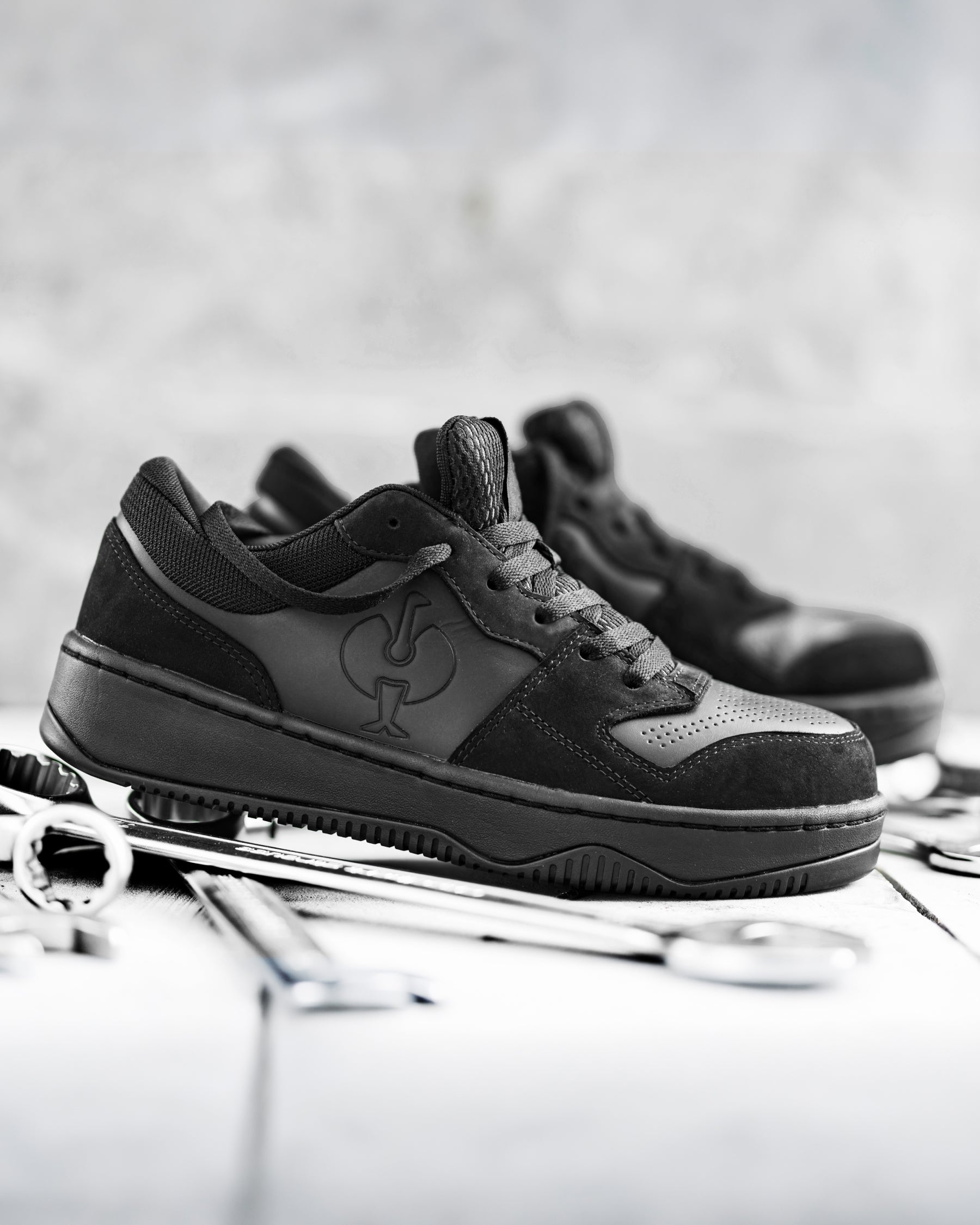 STRAUSS Eindhoven Steel Toe Work Shoe in Black worn in an outdoor work setting