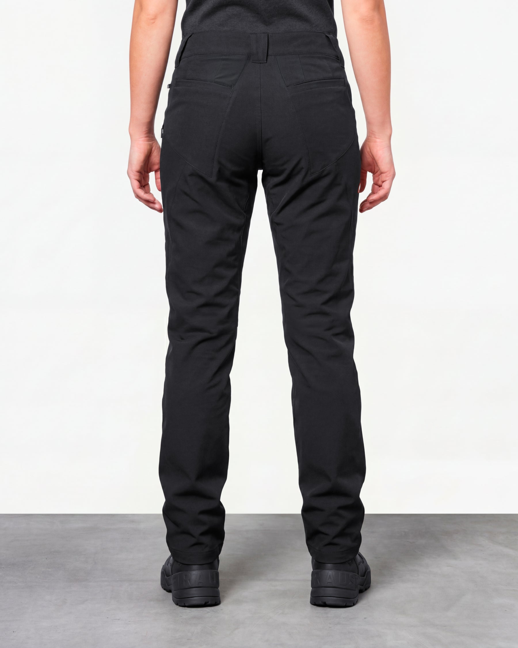 Women's Utility Cargo Work Pants in black worn by a model, rear view