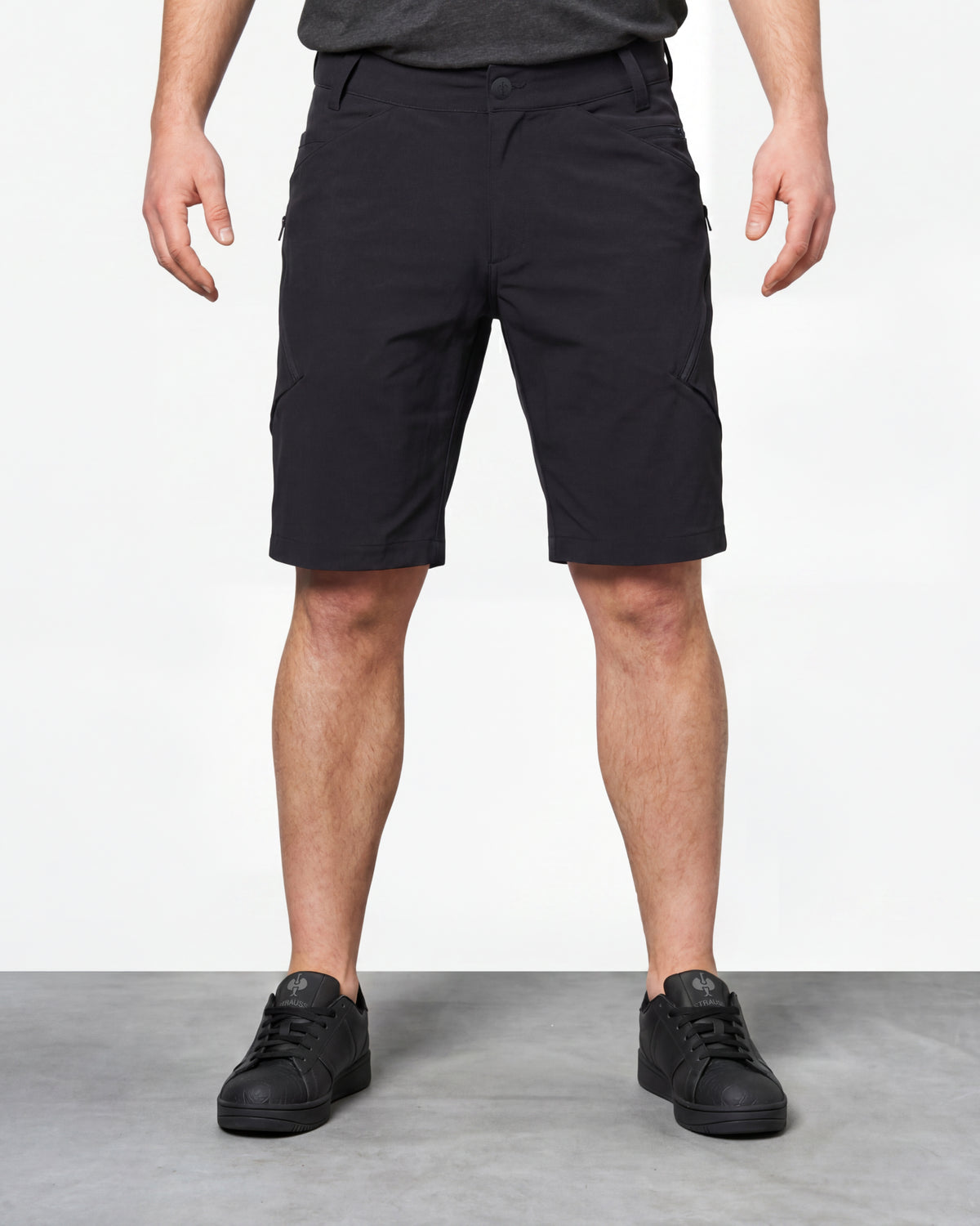 Model wearing Engelbert Strauss utility cargo work shorts in black, showing the fit, length, waistband, and front pocket layout of the black utility cargo work shorts with multiple storage pockets.