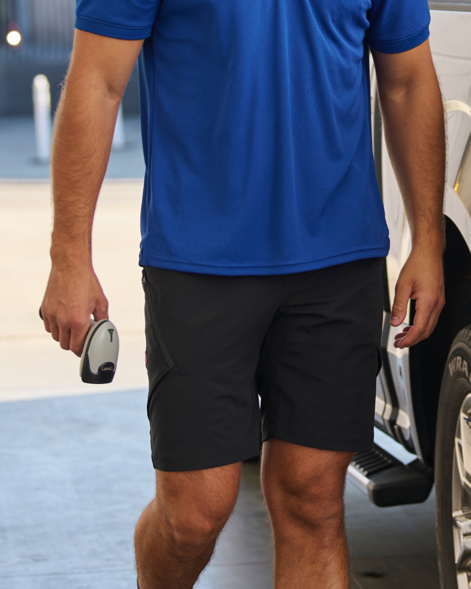 Engelbert Strauss utility cargo work shorts in black in an in-use workwear scene, showing the shorts worn during active movement and emphasizing comfort and mobility.