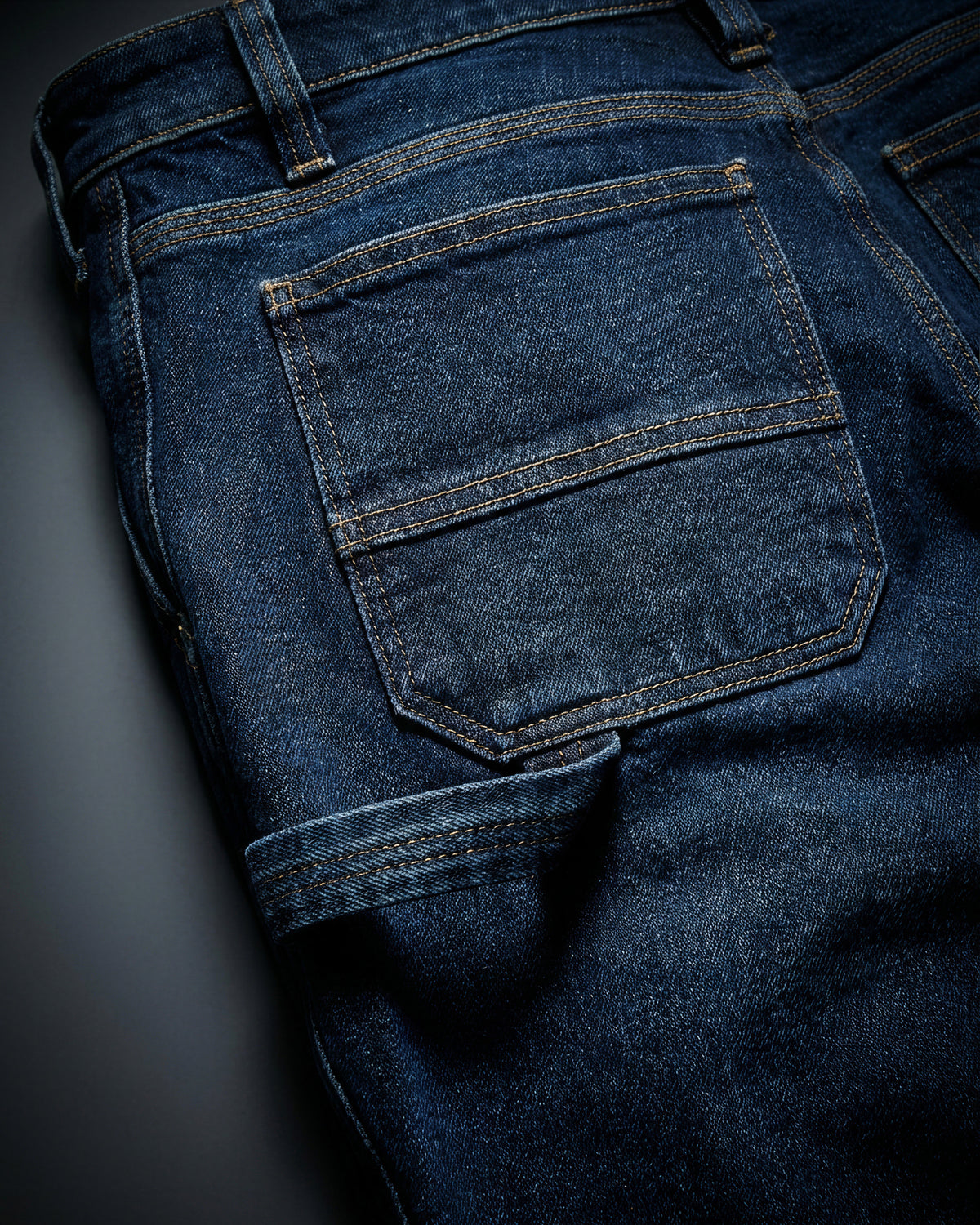 Close-up of denim pocket and stitching on Carpenter Jeans e.s.iconic in dark wash