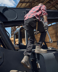 Power Denim 5-Pocket Jeans in blackwashed shown in an outdoor workwear setting