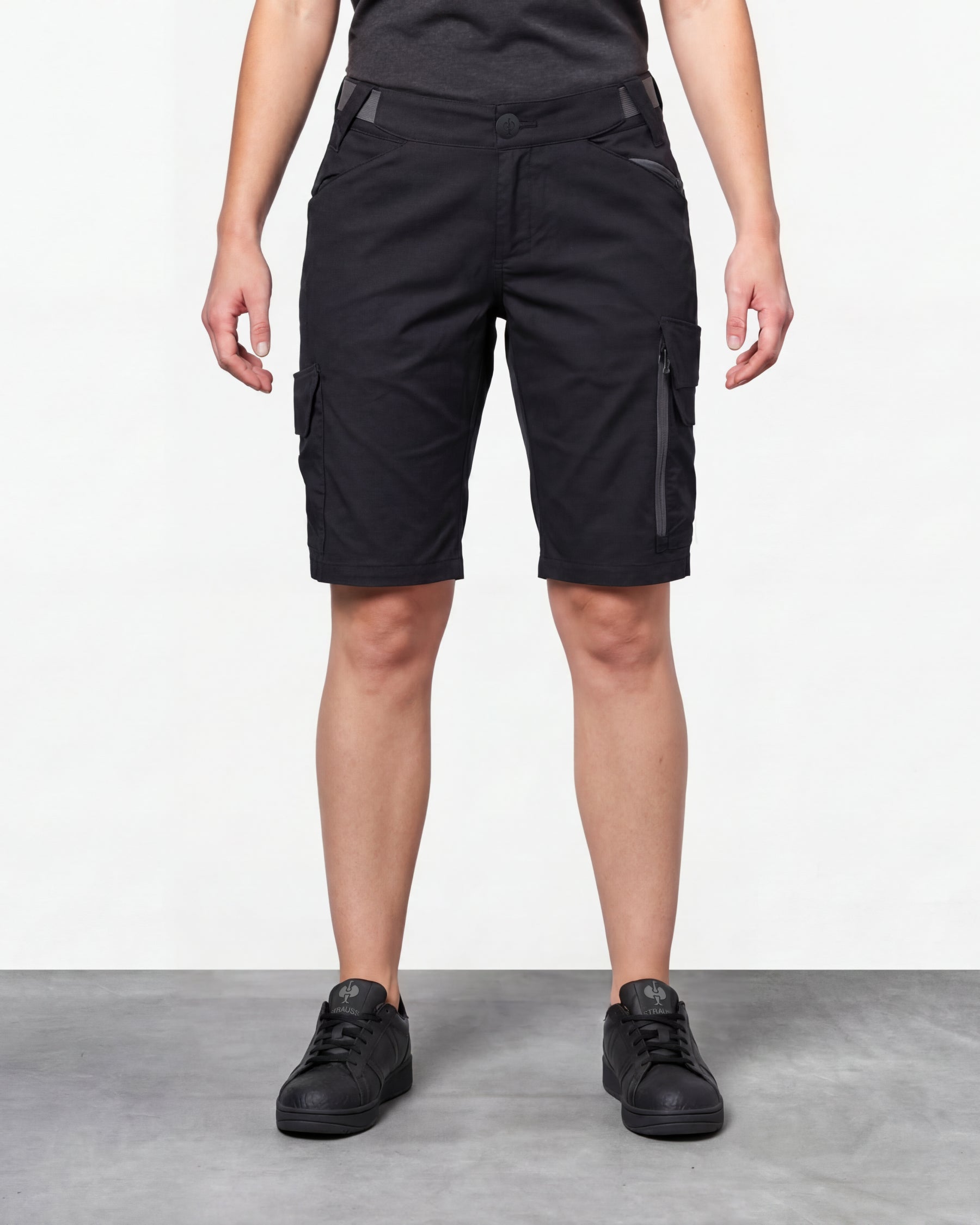 Model wearing Engelbert Strauss women's e.s. trail pure cargo work shorts in black and carbon gray, showing the fit, length, waistband, and front pocket layout of the two-tone women’s cargo work shorts with reinforced utility styling.